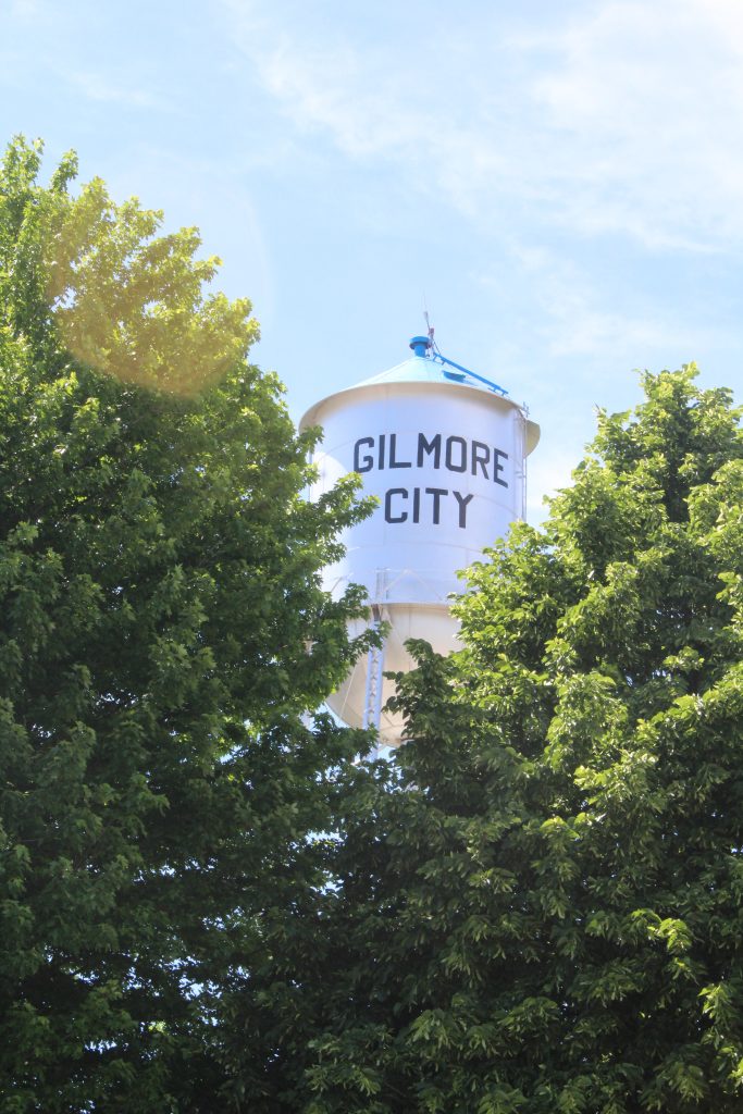 View of Gilmore City water tower through trees